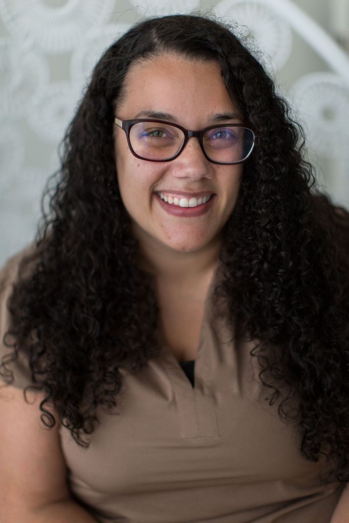 Brooke Brown, a woman with brown curly hair and glasses